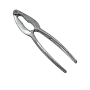 Stainless steel nut cracker with various nuts, including walnuts and almonds.