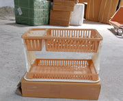 Modern black dish rack with various kitchen utensils draining into a tray.