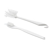Cleaning brush with ergonomic handle on plain background