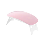 Hand curing gel nails under the portable Gel Nail Dryer.