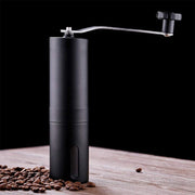 Siplix portable stainless steel manual coffee grinder standing upright.
