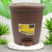 Small white pedal dustbin placed in a modern kitchen, ideal for daily use.