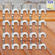Close-up of steel nail gripping a plastic cable clip for dependable wire holding