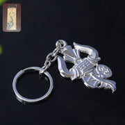 Silver metal Trishul Damru keychain shown on a white background