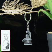 Front view of silver Shivling keychain featuring intricate snake motif