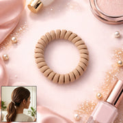 Spiral coil hair band in black and silver, designed for a gentle hold.