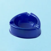 Side view of dark blue plastic ashtray with smokeless deep bowl
