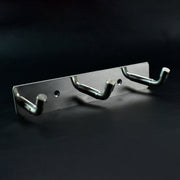 Polished metallic 3 hook rack mounted on bedroom wall