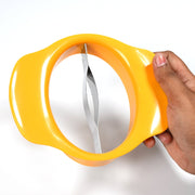 Hand holding the mango slicing tool over a mango, demonstrating its ergonomic design.