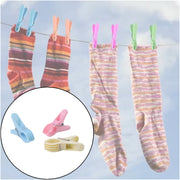 Pink plastic cloth clip securely holding fabric in place