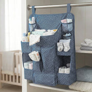 Close-up of storage pockets in baby care organizer for bottles and lotions