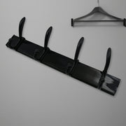 Top-down view of the 4-hook wall mount coat hanger holding various coats and hats.