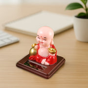 Solar Buddha Car Ornament placed on a car dashboard, adding a serene touch to the vehicle's interior.