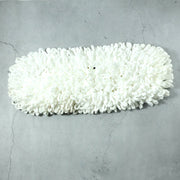Freshly washed dust mop refill head drying naturally.