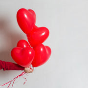Lively party setting adorned with multiple heart shaped balloons.
