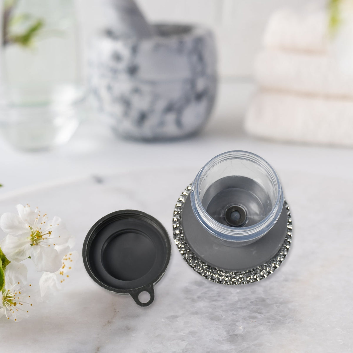 Compact kitchen cleaning brush with an integrated soap dispenser, ideal for small spaces.