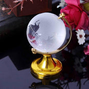 Crystal World Globe with golden stand, presented in a minimalist setting to emphasize its design.