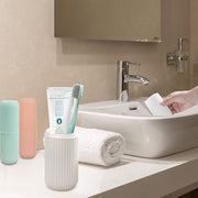 Blue travel toothbrush holder securely containing a toothbrush and toothpaste.