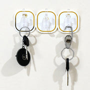 Close-up of a clear plastic transparent adhesive hook with a stainless steel hook.