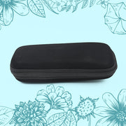 A black, rectangular zippered case with rounded corners is centered against a light blue background with floral outlines.
