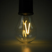 A close-up of the clear bulb of a portable LED tent light shows the glowing orange filament against a dark background.