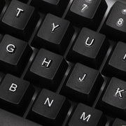 Angled view of the wired keyboard, highlighting its full-size layout and ergonomic key placement.