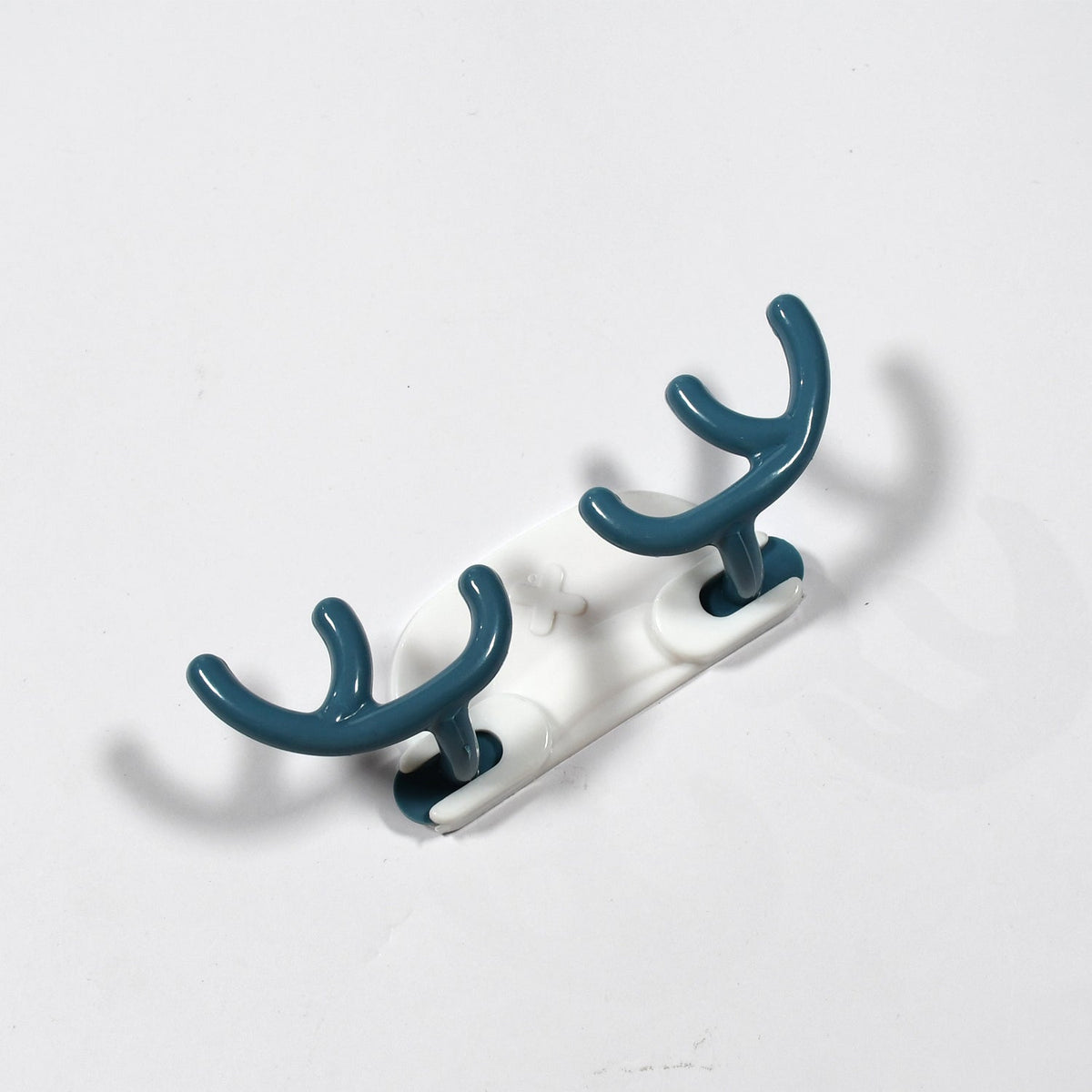 Side view of a white plastic wall hook securely attached to a wall.