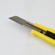 Retractable blade utility knife demonstrating its compact design.