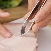 Fish bone tweezer placed on kitchen countertop showing ergonomic handle