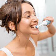 Side view of the electric toothbrush, showcasing its sleek design.