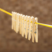 Sturdy bamboo wooden cloth clips with stainless steel springs, ready for household use.