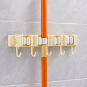 Close-up image of broom holder's multi-roller grip system on wall