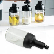 A Heat-Resistant Glass Seasoning Jar with integrated spoon, perfect for kitchen use.