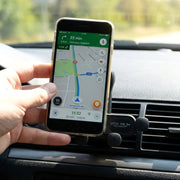 Side view showing installation of car air vent phone holder into vent blades