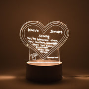 Workspace decorated with glowing 3D acrylic visualization lamp and drawing