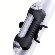 Rechargeable LED bicycle light with USB charging port for convenient power.