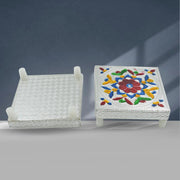 Top view of the Meenakari chowki with a small diya and puja items, ready for worship.
