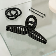 Back view of woman wearing hair claw clip holding elegant updo securely