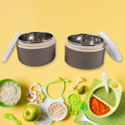 A collection of Ganesh stainless steel lunch boxes in various vibrant colors.