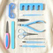 Manicure and pedicure grooming tool set with cleaning brush