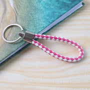 Hand strap loop detail of braided leather keychain enhancing portability