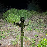 Person using a compact keychain flashlight for outdoor activities