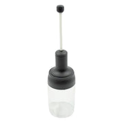 The sleek design of the Heat-Resistant Glass Seasoning Jar on a kitchen counter.