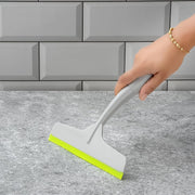 Kitchen wiper effectively cleaning a glass surface, leaving it spotless.