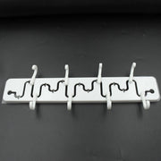 Modern adjustable wall hook installed in a bathroom, holding a towel.