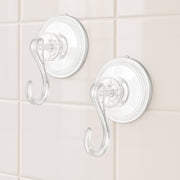 Four plastic suction cup hooks arranged for hanging items