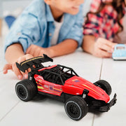 Red RC race car showing action shot on rough terrain for kids
