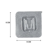 Multiple self-adhesive transparent hooks neatly organized on a surface.