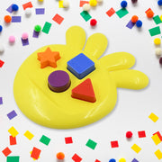The unique octagonal base of the Octo Shape Sorter Toy filled with colorful, sorted shapes.
