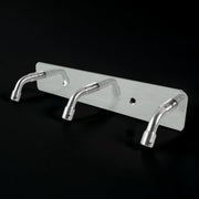 Stainless steel coat hook rack holding towels and bags